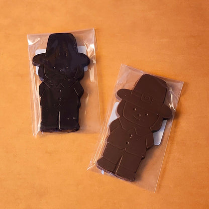 Add a touch of holiday tradition to your Thanksgiving celebrations with our Boy Pilgrim Chocolate Favor. Available in smooth milk chocolate or rich dark chocolate, this adorable pilgrim-shaped treat is perfect as a table favor, a small gift, or a delicious addition to your dessert table