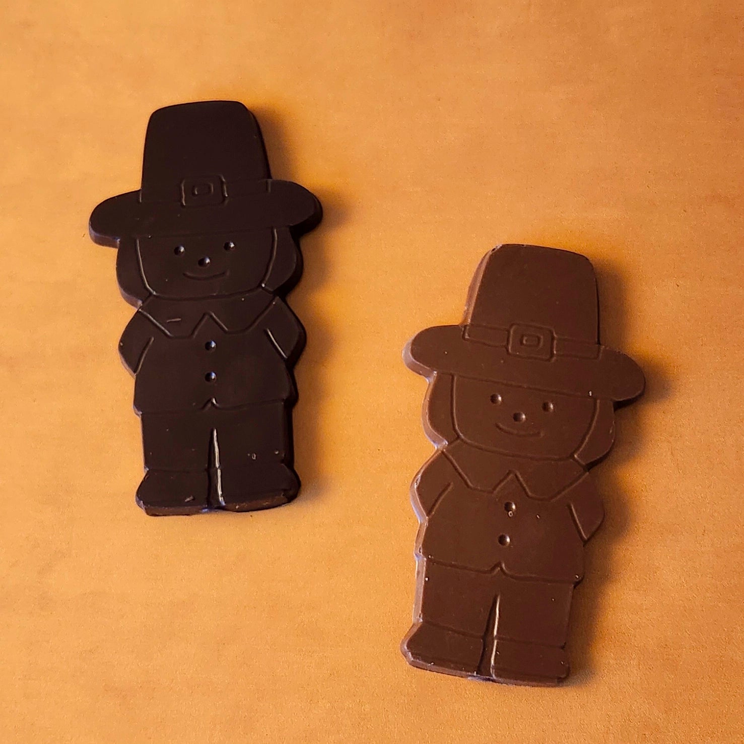 Add a touch of holiday tradition to your Thanksgiving celebrations with our Boy Pilgrim Chocolate Favor. Available in smooth milk chocolate or rich dark chocolate, this adorable pilgrim-shaped treat is perfect as a table favor, a small gift, or a delicious addition to your dessert table