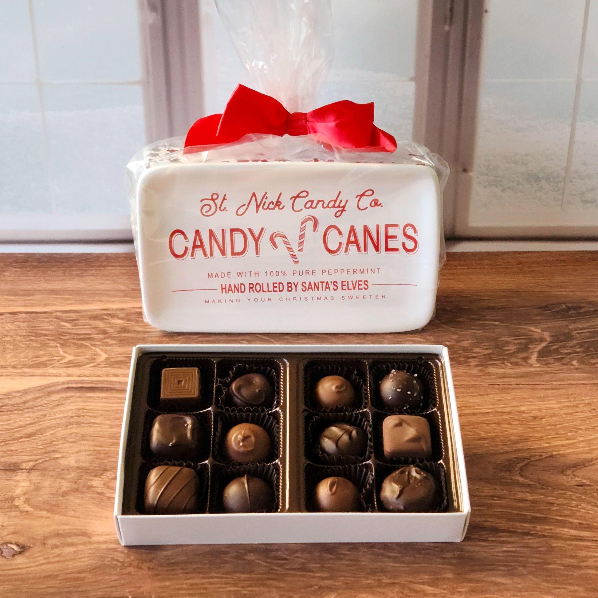 These holiday-themed trays are paired with a 12-piece assortment of our popular milk and dark chocolates, featuring delicious truffles, creams, caramels, and meltaways. Perfect as a thoughtful gift or festive centerpiece, each tray is beautifully wrapped with a bow for that extra holiday touch.