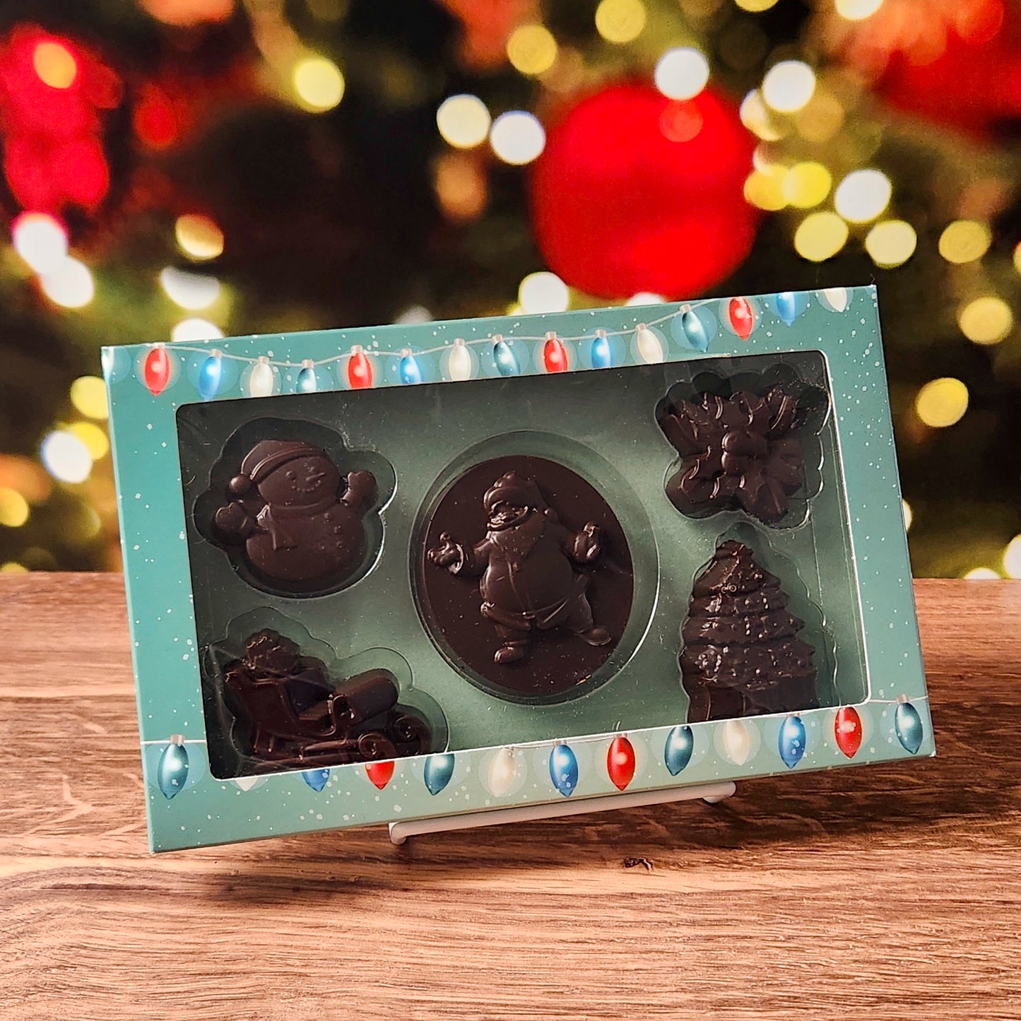 Celebrate the season with our Merry Christmas Dark Chocolate Box Set, filled with holiday cheer in every bite! This charming collection includes beautifully molded chocolates shaped like a jolly Santa, a classic snowman, a festive sleigh, delicate holly, and a shimmering Christmas tree—each crafted to bring the magic of Christmas right to your taste buds