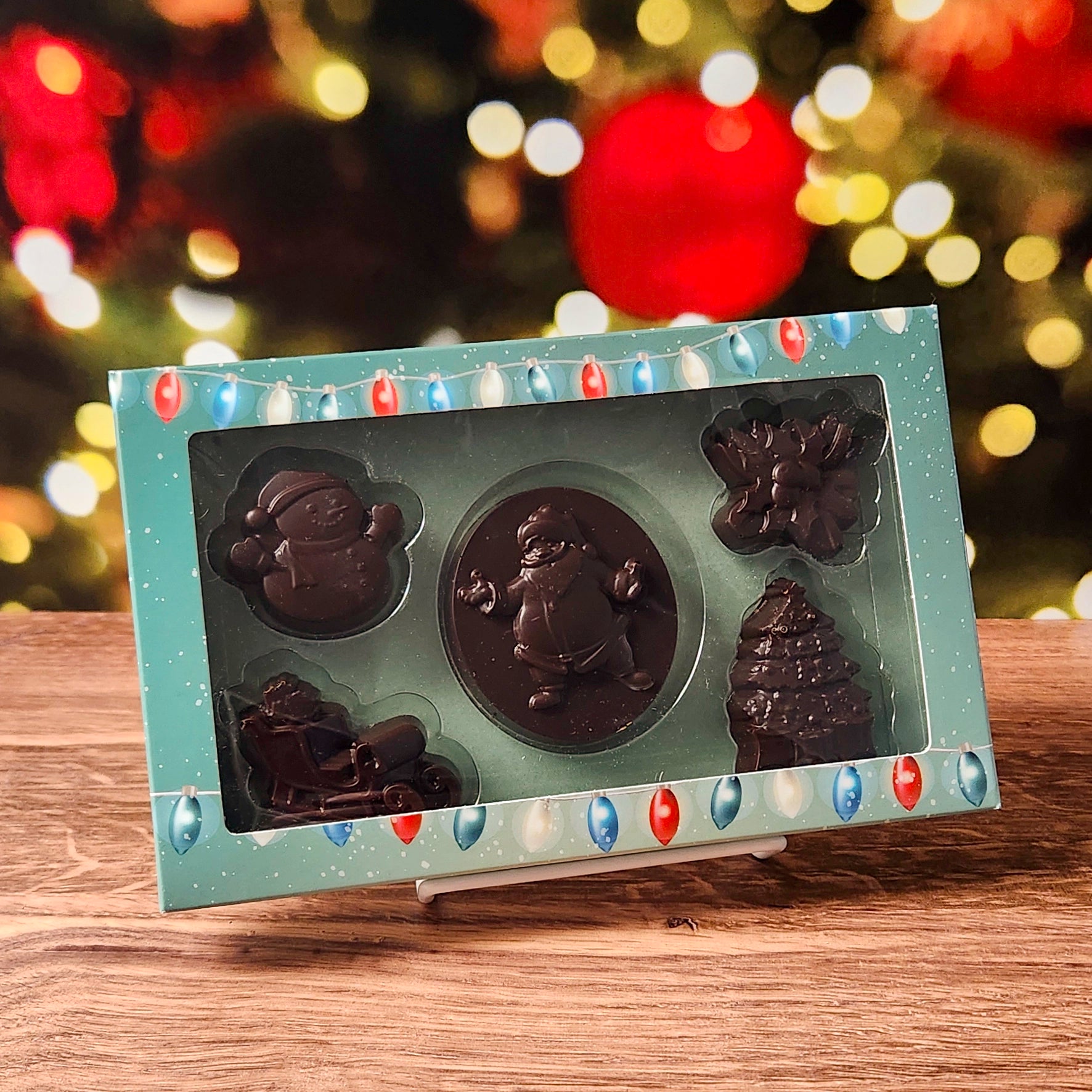 Celebrate the season with our Merry Christmas Dark Chocolate Box Set, filled with holiday cheer in every bite! This charming collection includes beautifully molded chocolates shaped like a jolly Santa, a classic snowman, a festive sleigh, delicate holly, and a shimmering Christmas tree—each crafted to bring the magic of Christmas right to your taste buds