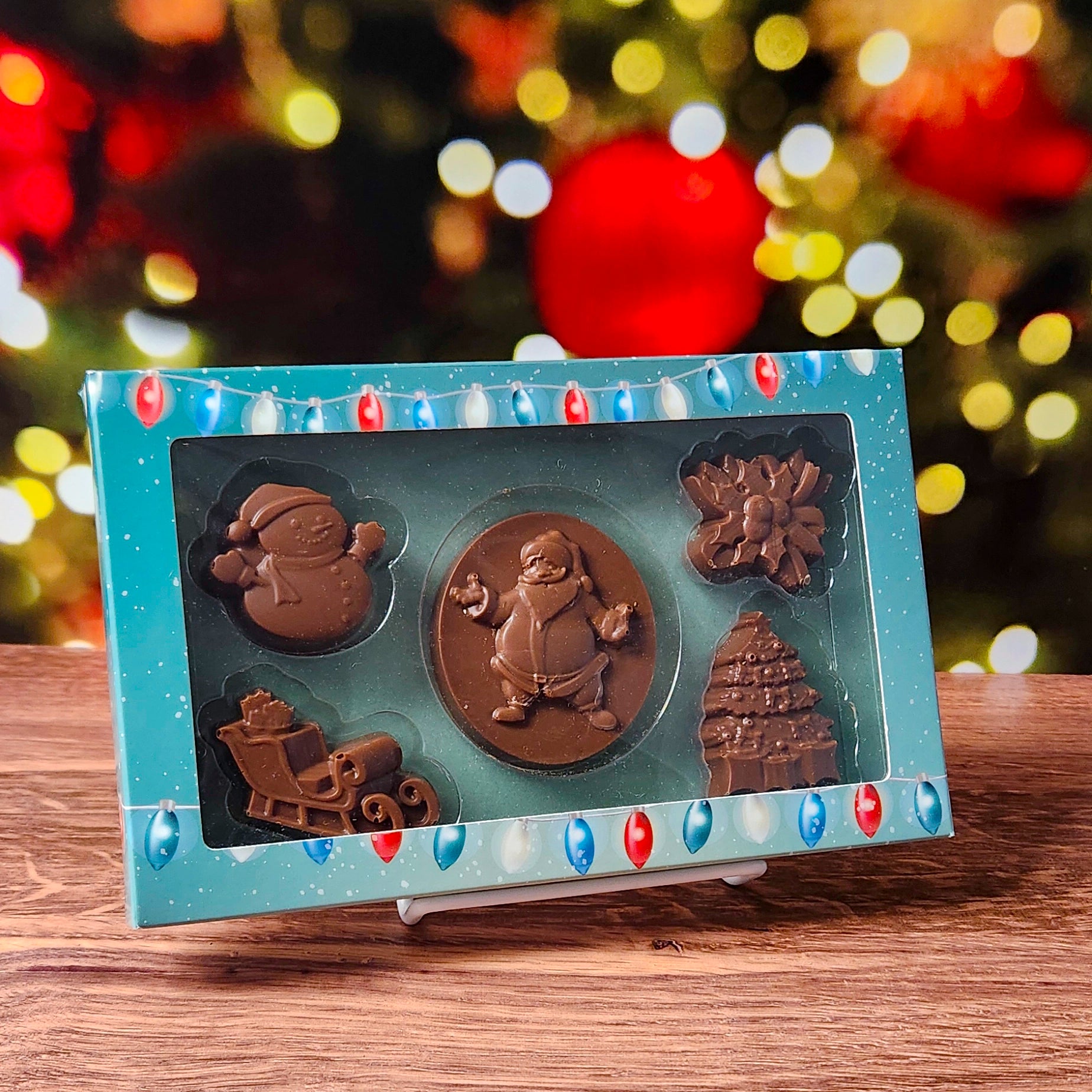 Celebrate the season with our Merry Christmas Milk Chocolate Box Set, filled with holiday cheer in every bite! This charming collection includes beautifully molded chocolates shaped like a jolly Santa, a classic snowman, a festive sleigh, delicate holly, and a shimmering Christmas tree—each crafted to bring the magic of Christmas right to your taste buds