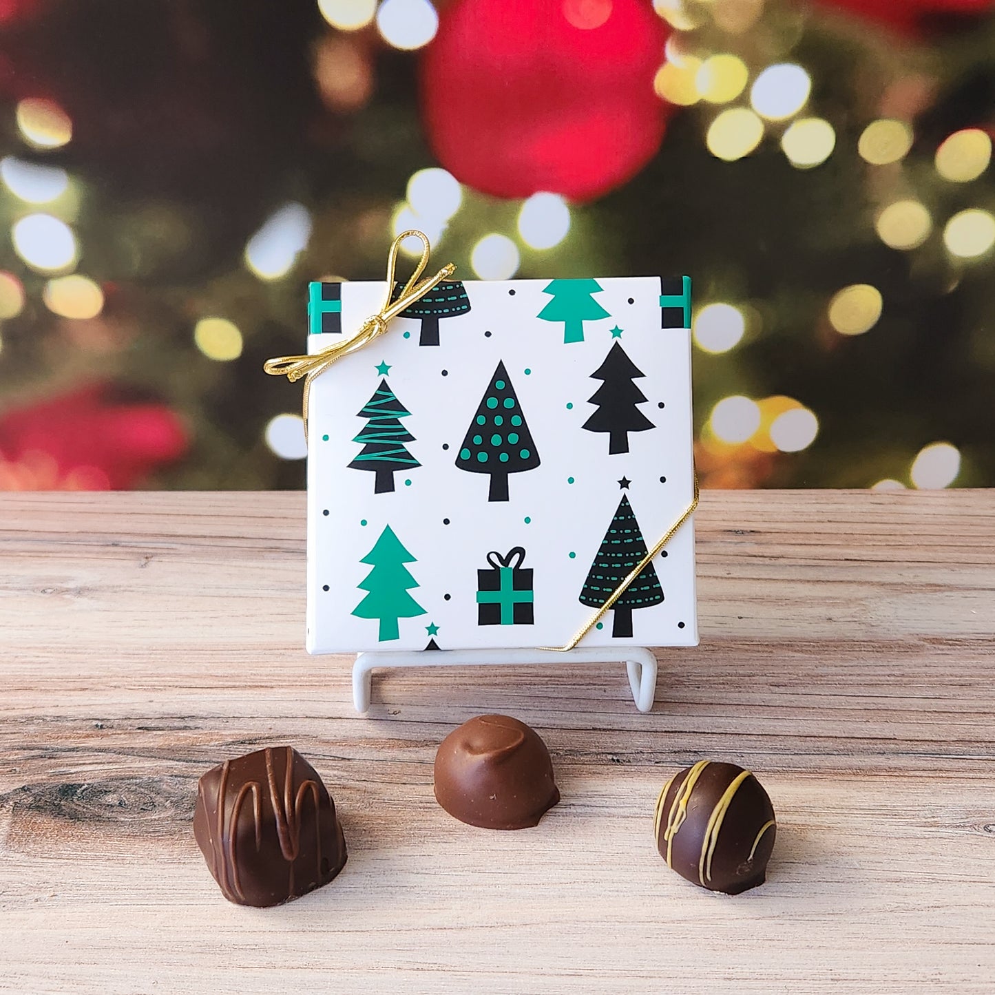 An assortment of our most popular milk and dark chocolate creams, caramels, melt-aways, and truffles all packed inside a box with a festive Christmas Trees printed on the cover.