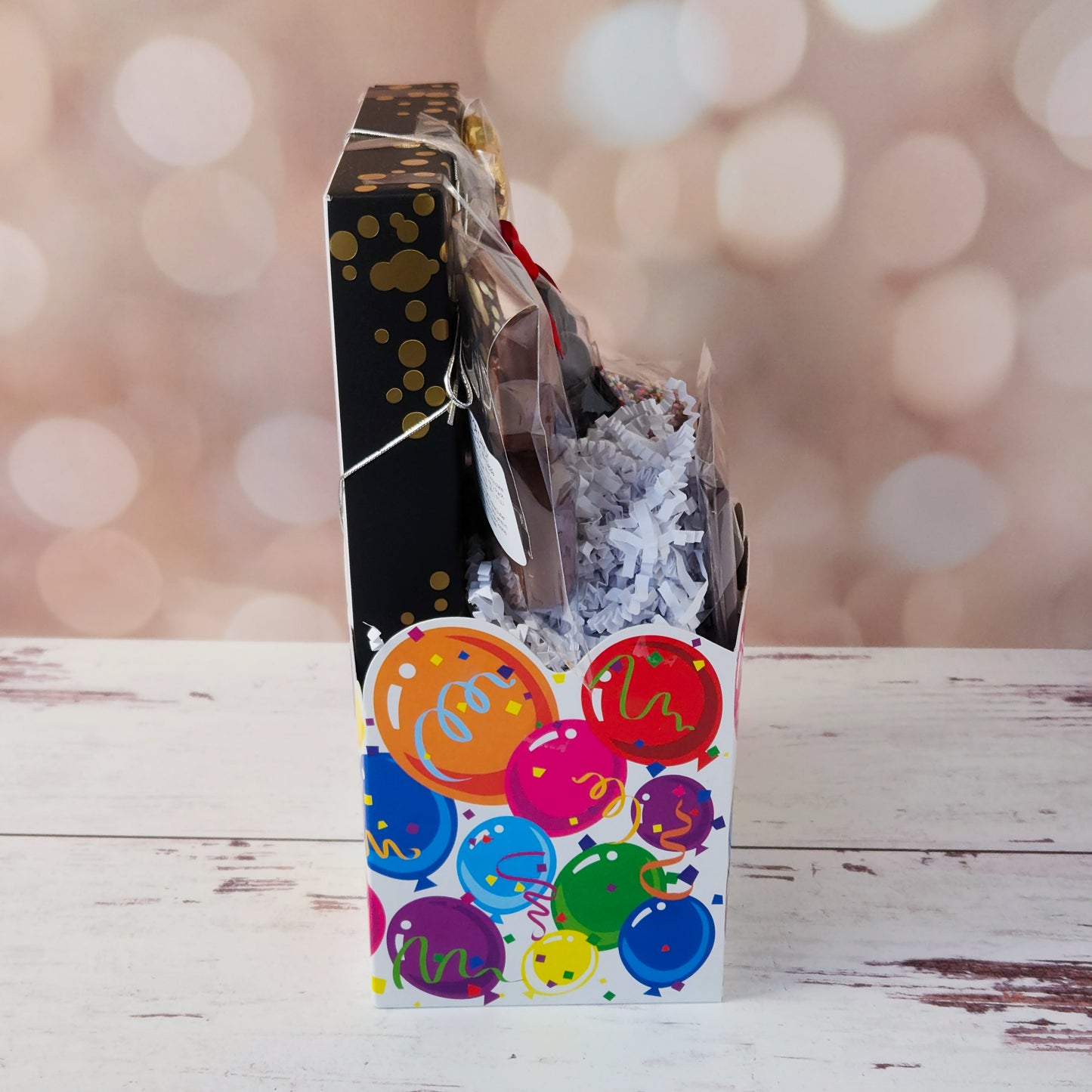 Make life’s big moments even sweeter with our Celebrate Gift Basket!
Inside, you’ll find a mix of gold and silver foiled milk chocolate stars, two chocolate-covered Oreo cookies, and classic milk chocolate nonpareils. A milk chocolate card that says “Congratulations”, dark chocolate-covered cranberries and a luxurious 16-piece assortment of creams, caramels, meltaways, and truffles. All overwrapped with a bow and ready for gifting!