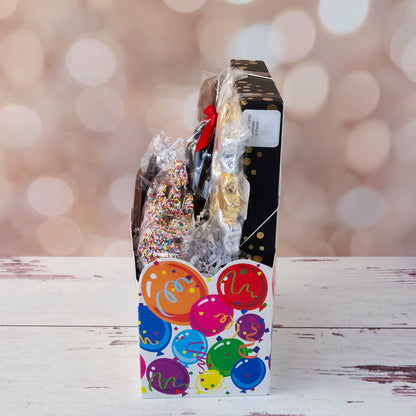 Make life’s big moments even sweeter with our Celebrate Gift Basket!
Inside, you’ll find a mix of gold and silver foiled milk chocolate stars, two chocolate-covered Oreo cookies, and classic milk chocolate nonpareils. A milk chocolate card that says “Congratulations”, dark chocolate-covered cranberries and a luxurious 16-piece assortment of creams, caramels, meltaways, and truffles. All overwrapped with a bow and ready for gifting!