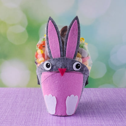 This adorable felt bunny-shaped basket is filled with a delicious assortment of Chocolate-Dipped Marshmallow Peeps, fruity Jelly Beans, Sanded Gummi Bunnies, and a Chocolate Bunny Favor. Wrapped in overwrap and finished with a beautiful bow