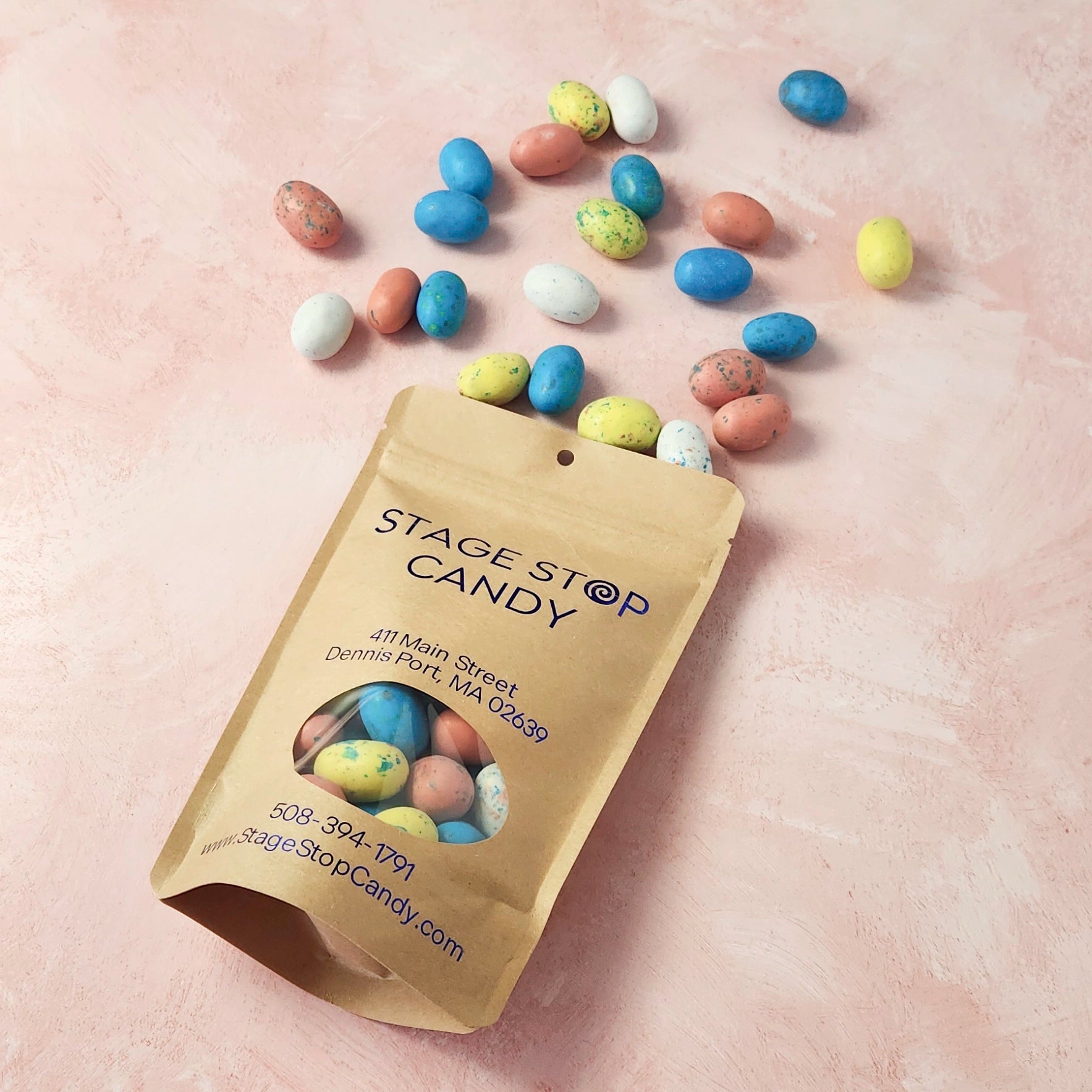 Stage Stop Candy packaging with colorful candies spilling out on a beige background