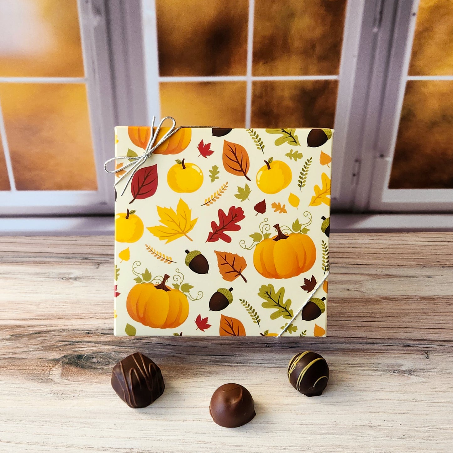 An assortment of our most popular milk and dark chocolate creams, caramels, melt-aways, and truffles all packed inside a box with a fun fall print featuring pumpkins, leaves and acorns.