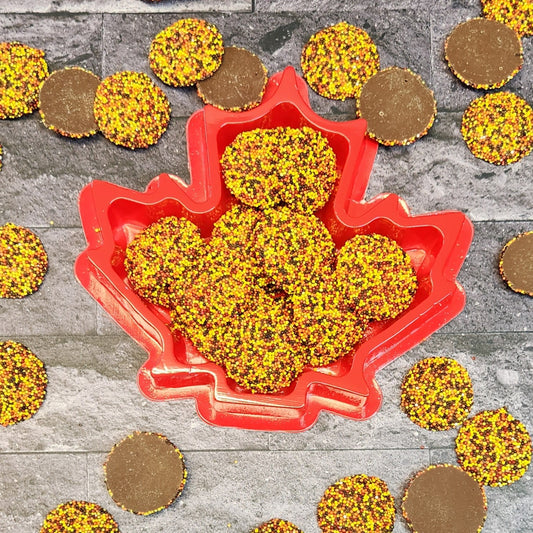 Snuggle up with these delectable milk chocolate nonpareils in a charming leaf-shaped box. Adorned with festive fall colors, it's the perfect cozy treat for the season!