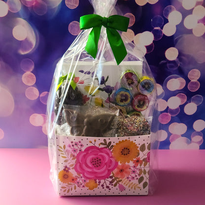 Flowers and butterflies decorate this beautiful floral gift basket. Filled with all your chocolate favorites.