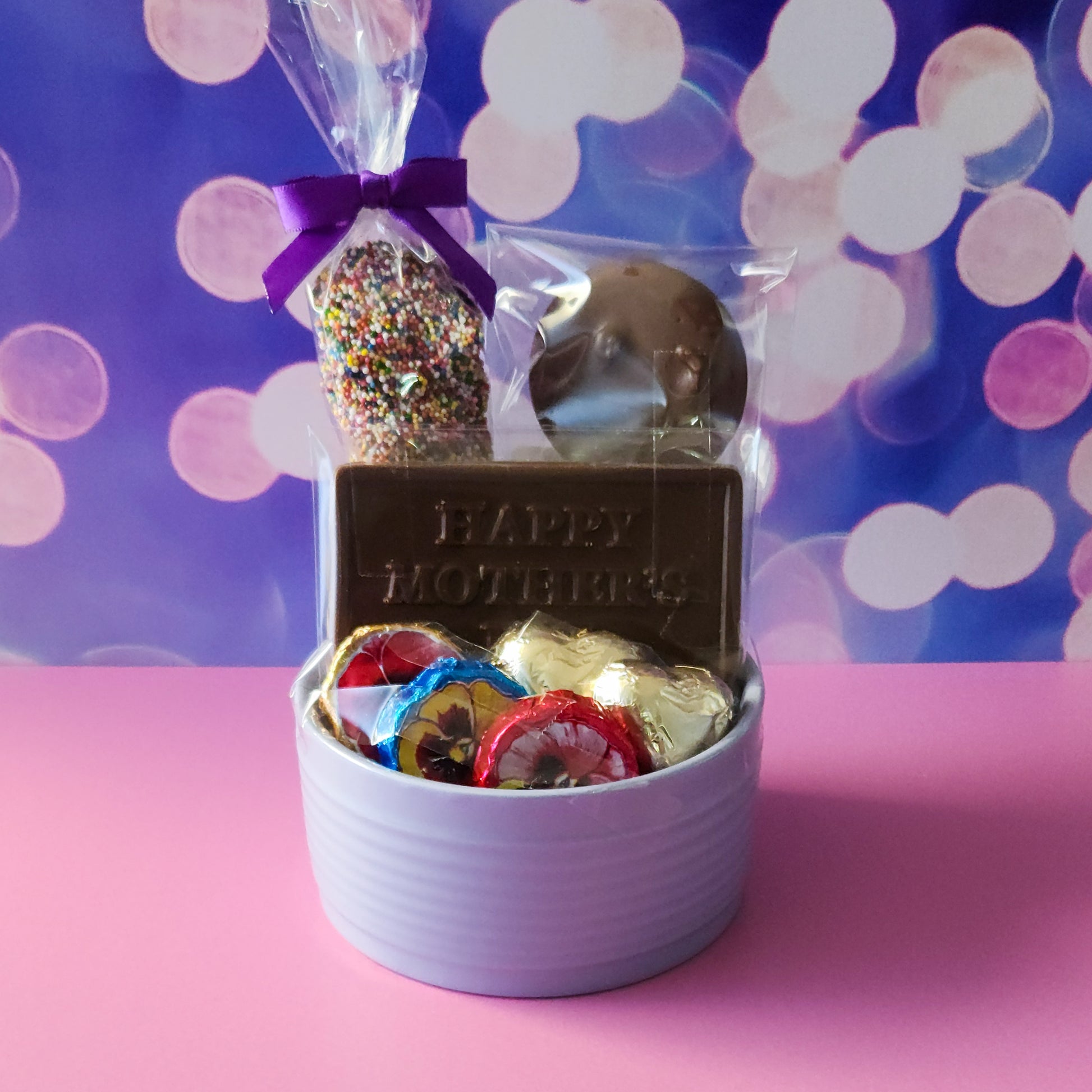 What a sweet treat for mom. This candy dish features nonpareils, chocolate dipped oreos, foiled hearts, foiled flowers and a Milk Chocolate card that reads Happy Mother's Day.