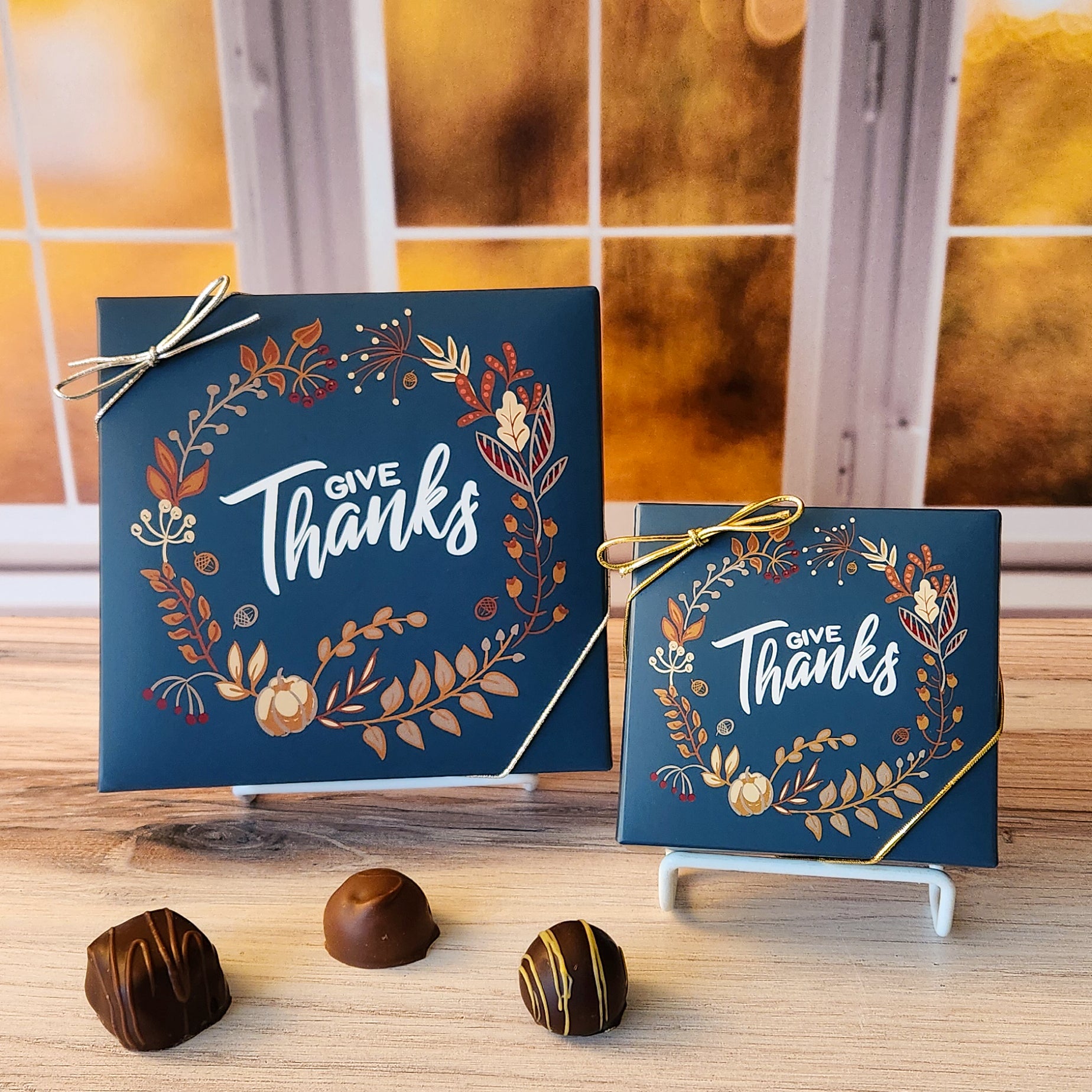 An assortment of our most popular milk and dark chocolate creams, caramels, melt-aways, and truffles all packed inside a box with the words "Give Thanks" printed on the cover.