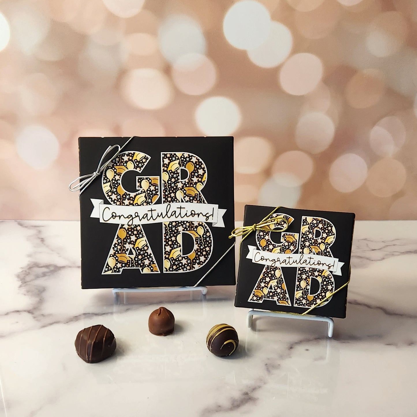 An assortment of our most popular milk and dark chocolate creams, caramels, melt-aways, and truffles all packed inside a festive box. On the cover of the box the word GRAD is printed surrounded by a banner that says Congratulations!