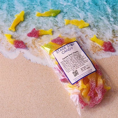 Dare to face your fears with Gummi Sour Sharks! Take a bold bite, and feel the sour shock of adventure.
Flavors include: Apple, lemon, raspberry, pear, and orange.
Packed in a 6 ounce bag