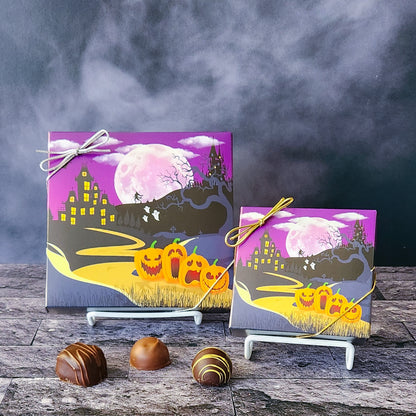 An assortment of our most popular milk and dark chocolate creams, caramels, melt-aways, and truffles all packed inside a box with a spooky Halloween Night printed on the cover.