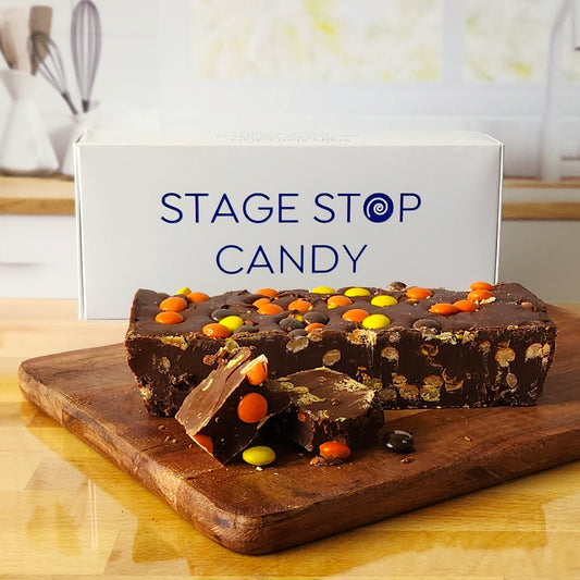 Made in a traditional copper kettle, this gourmet treat features a rich chocolate fudge base generously mixed with Reese's Pieces, offering a delightful combination of smooth chocolate and crunchy peanut butter candy.