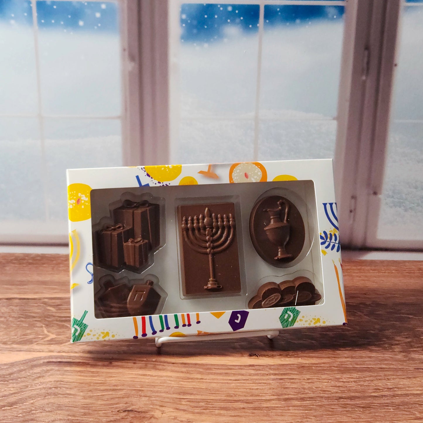 Celebrate the joy of Hanukkah with our festive Hanukkah Milk Chocolate Box Set! This delightful assortment features solid chocolates shaped like traditional holiday symbols, including dreidels, menorahs, and more.