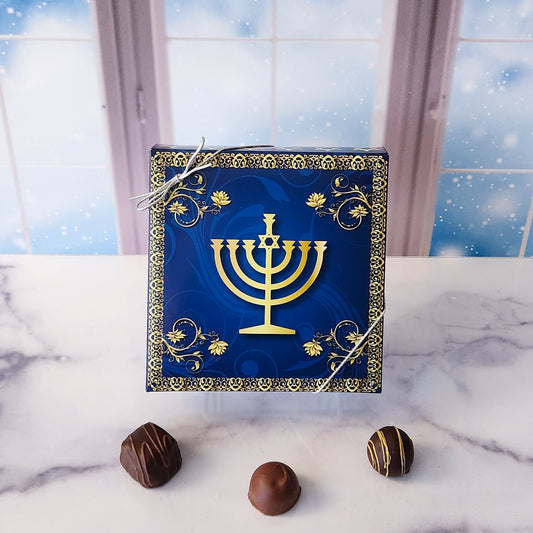 An assortment of our most popular milk and dark chocolate creams, caramels, melt-aways, and truffles all packed inside a box with an elegant Menorah printed on it.