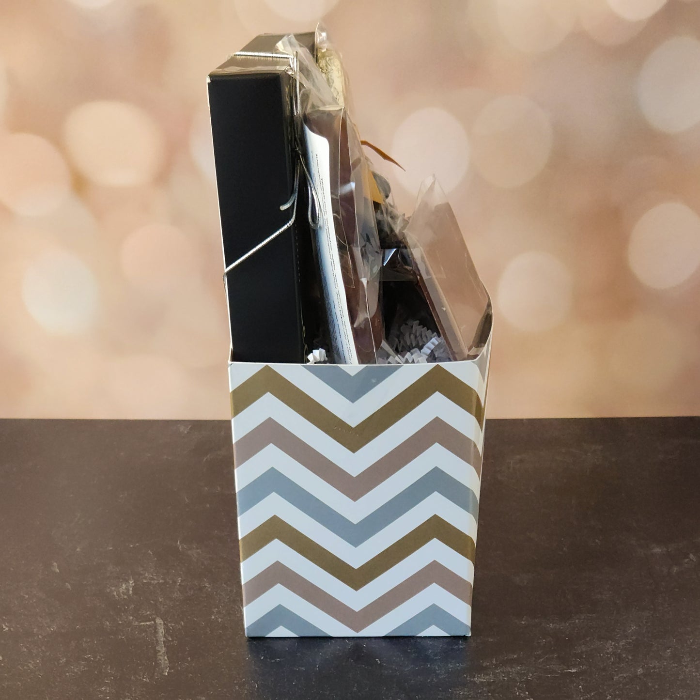 Happy Anniversary Gift Basket.
foiled milk chocolate hearts, dark chocolate–covered cranberries, milk chocolate‑covered Oreos and milk chocolate nonpareils. Topped with a whimsical milk chocolate card that reads “Happy Anniversary,” it’s a heartfelt way to express your love. The centerpiece is a 16‑piece gift box filled with an assortment of creams, caramels, meltaways, and truffles. 