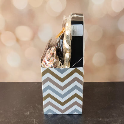 Happy Anniversary Gift Basket.
foiled milk chocolate hearts, dark chocolate–covered cranberries, milk chocolate‑covered Oreos and milk chocolate nonpareils. Topped with a whimsical milk chocolate card that reads “Happy Anniversary,” it’s a heartfelt way to express your love. The centerpiece is a 16‑piece gift box filled with an assortment of creams, caramels, meltaways, and truffles. 