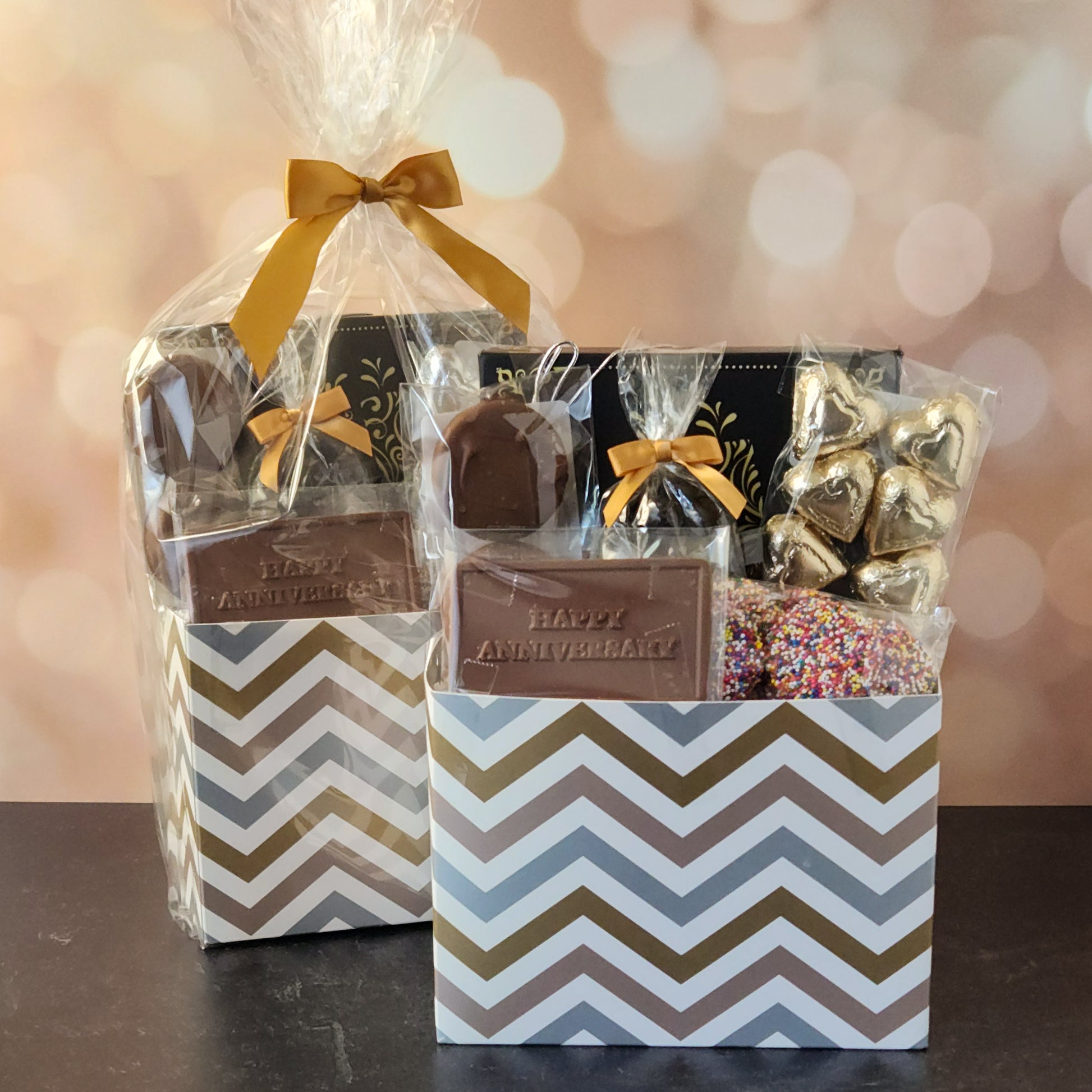 Happy Anniversary Gift Basket.
foiled milk chocolate hearts, dark chocolate–covered cranberries, milk chocolate‑covered Oreos and milk chocolate nonpareils. Topped with a whimsical milk chocolate card that reads “Happy Anniversary,” it’s a heartfelt way to express your love. The centerpiece is a 16‑piece gift box filled with an assortment of creams, caramels, meltaways, and truffles. 