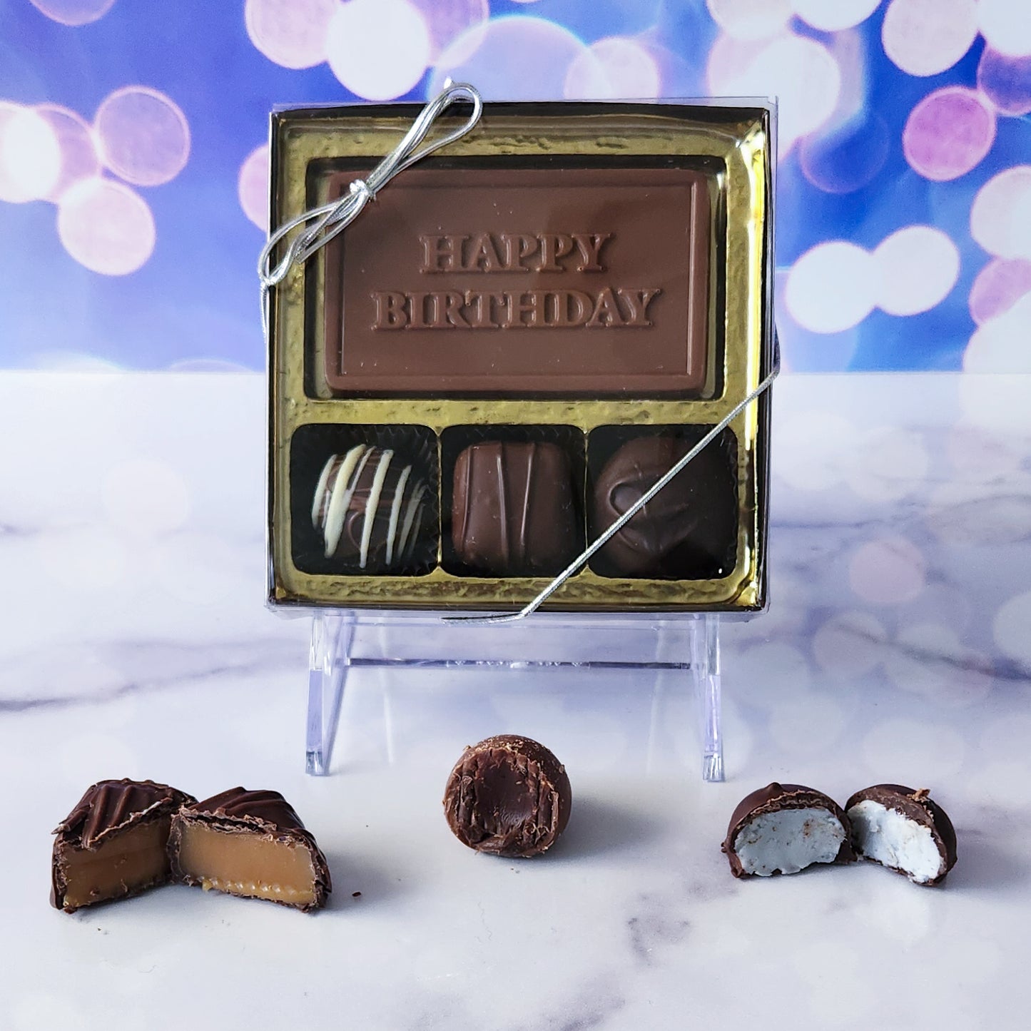Add a touch of sweetness to their special day with our 3-piece Happy Birthday Candy Box! Inside, a beautifully crafted milk chocolate card that says "Happy Birthday" is paired with a trio consisting of creamy soft center cream, a rich truffle, and a delightful caramel. It's the perfect petite treat to celebrate their birthday!