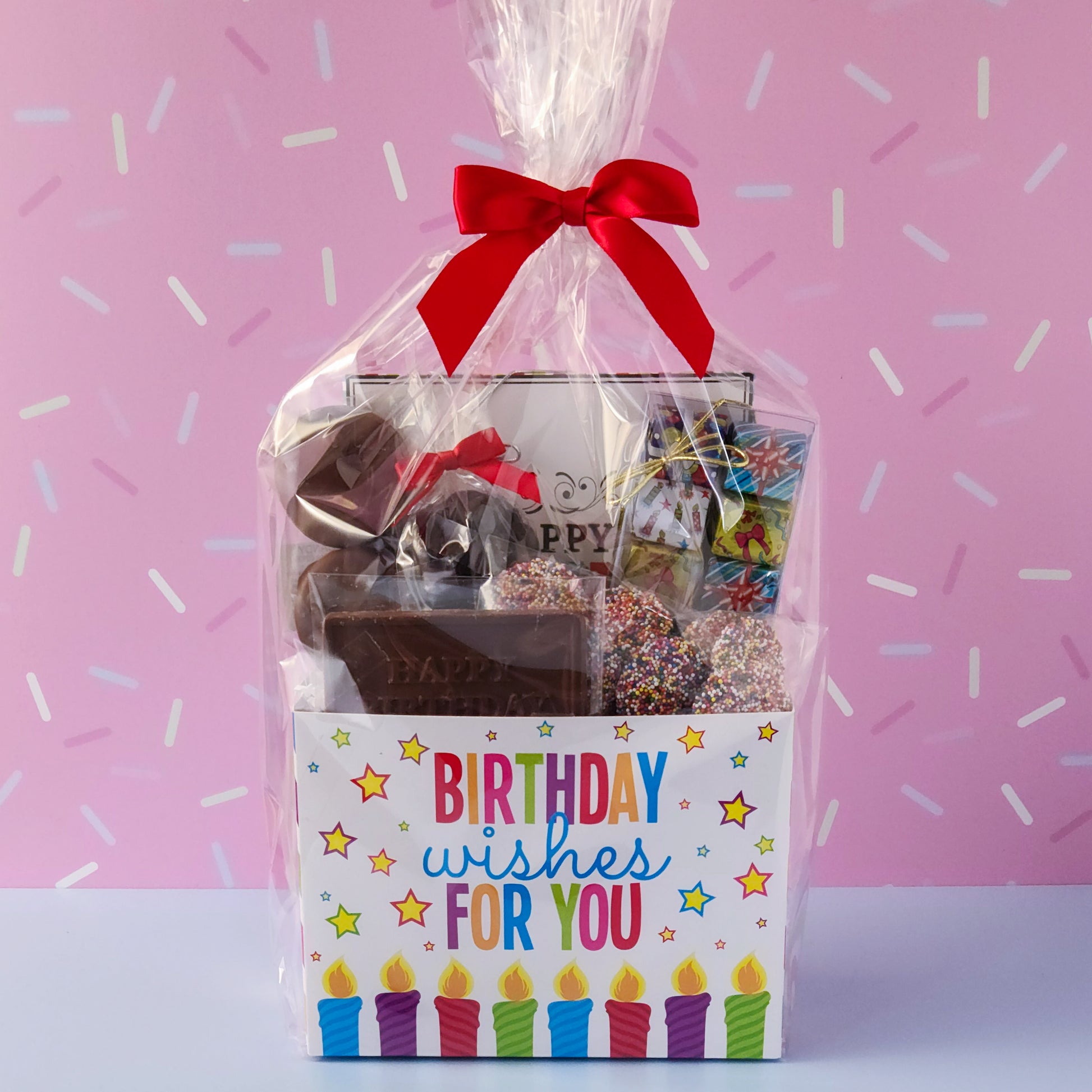 Make birthdays extra special with our Birthday Gift Basket, a delightful assortment of handcrafted chocolates that’s sure to bring a smile to any chocolate lover’s face! Packed with a delicious mix of milk and dark chocolate treats. 
16-Piece Milk and Dark Chocolate Assortment, Milk Chocolate "Happy Birthday" Card, Milk Chocolate Covered Oreos, Milk Chocolate Nonpareils & Foiled Presents, and Dark Chocolate Covered Cranberries all overwrapped and tied with a bow, this basket is ready to gift.