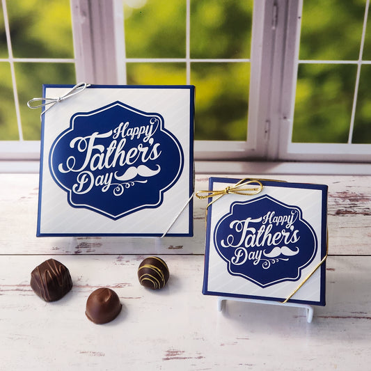 An assortment of our most popular milk and dark chocolate creams, caramels, melt-aways, and truffles all packed inside a box printed with the saying Happy Father's Day with a mustache printed under the words.