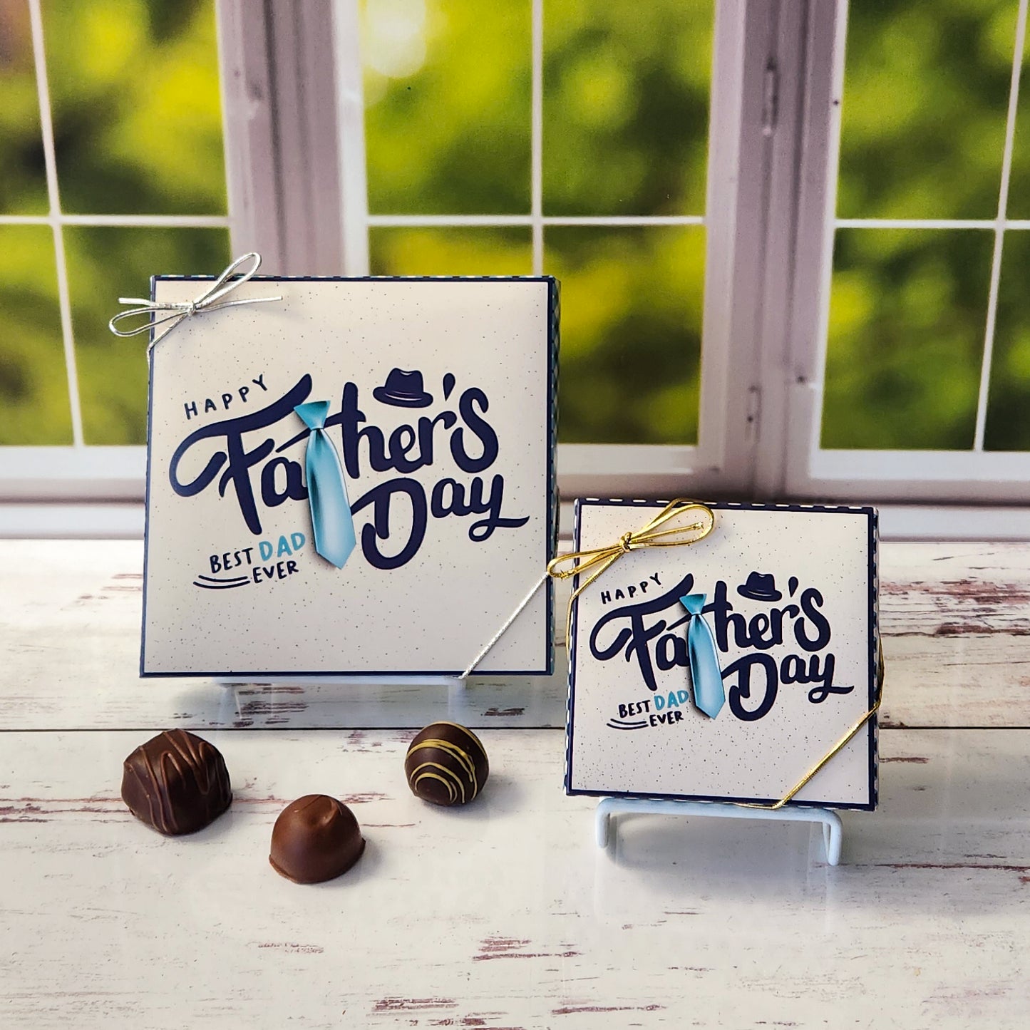 An assortment of our most popular milk and dark chocolate creams, caramels, melt-aways, and truffles all packed inside a box printed with the words Happy Father's Day with the T in Father shaped like a tie.