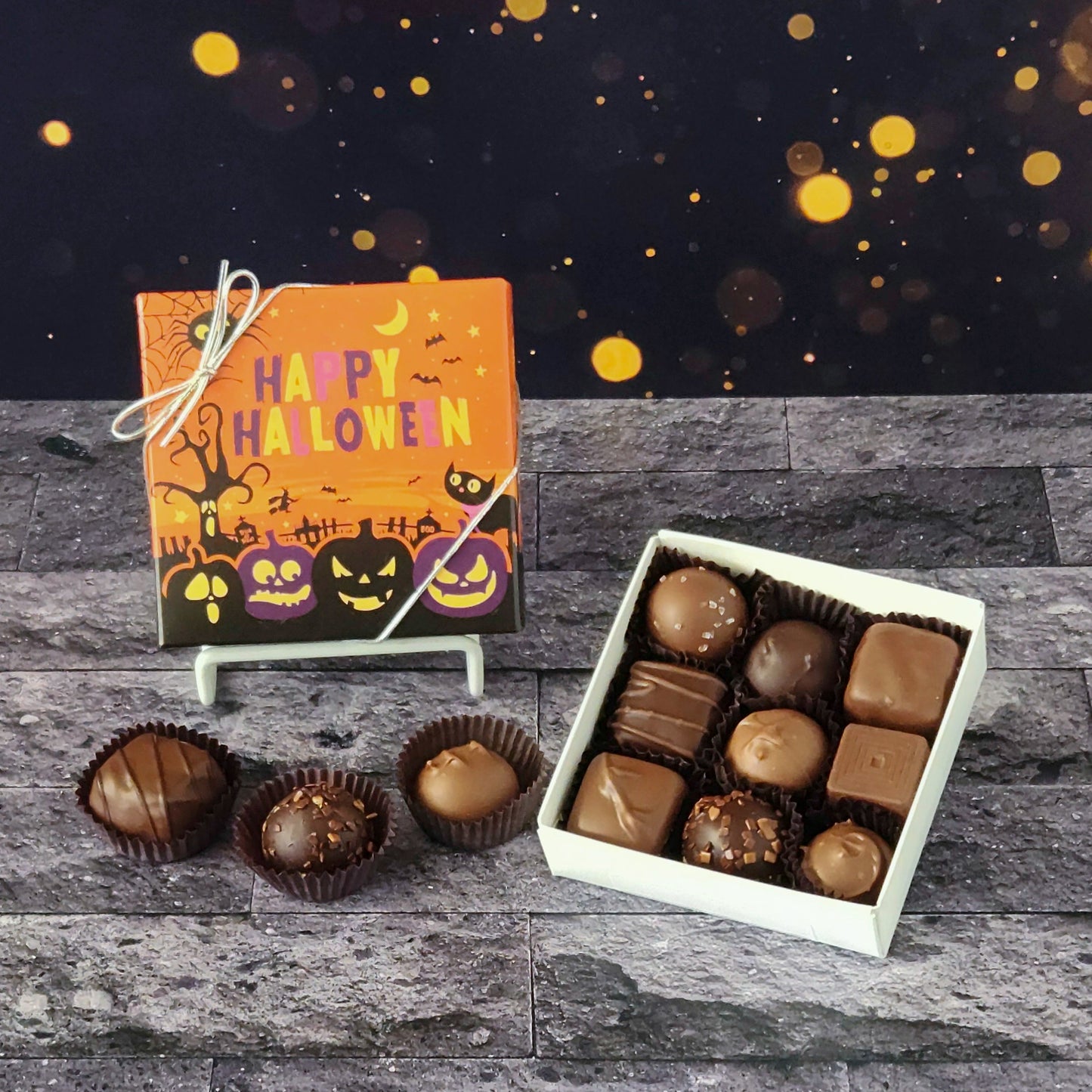 This Happy Halloween Assortment is available in 9-piece or 16-piece boxes, featuring a mix of milk and dark chocolate truffles, creams, caramels, and meltaways.