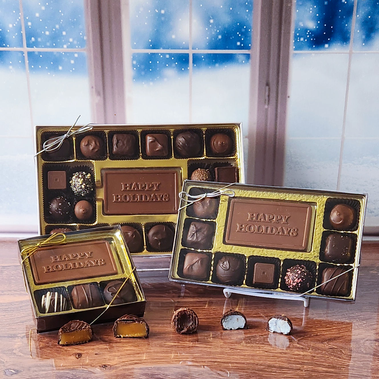 Spread festive cheer with our Happy Holidays Candy Box! Inside, a beautifully crafted milk chocolate card that says "Happy Holidays" is surrounded by a delightful assortment of milk and dark chocolate soft center creams, decadent truffles, and luscious caramels. It's the perfect way to sweeten the season and share joy with loved ones! 