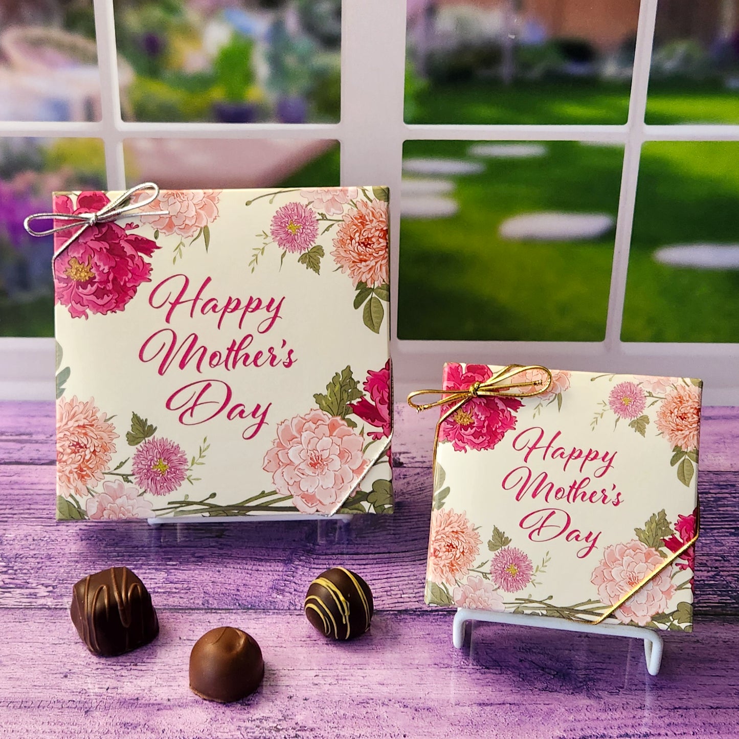 An assortment of our most popular milk and dark chocolate creams, caramels, melt-aways, and truffles all packed inside a box with the words "Happy Mother's Day" printed on a cream cover surrounded by flowers decorate this box lid.