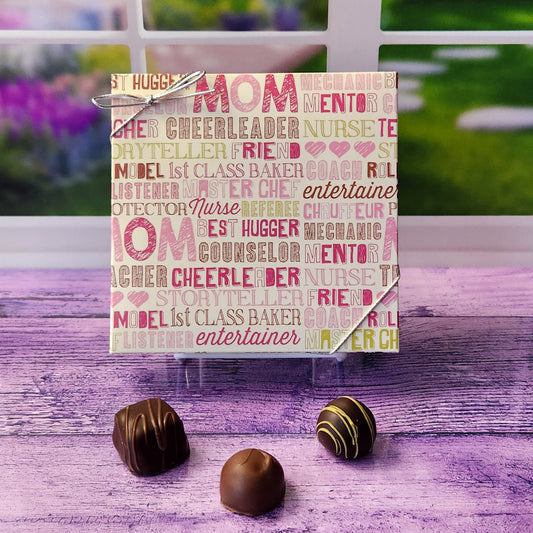 An assortment of our most popular milk and dark chocolate creams, caramels, melt-aways, and truffles all packed inside a box with words to celebrate Mom decorate this box lid.