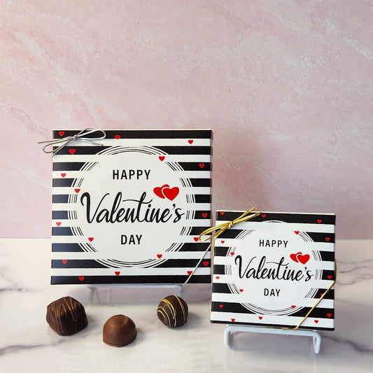 An assortment of our most popular milk and dark chocolate creams, caramels, melt-aways, and truffles all packed inside a festive box. On the cover of the box the words "Happy Valentine's Day is printed across a black and white stripe cover.