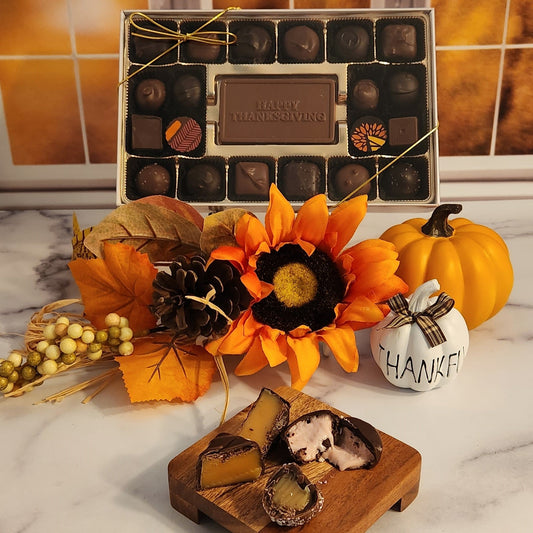 A stunning collection of 20 handcrafted chocolates, featuring a milk chocolate card that says Happy Thanksgiving.