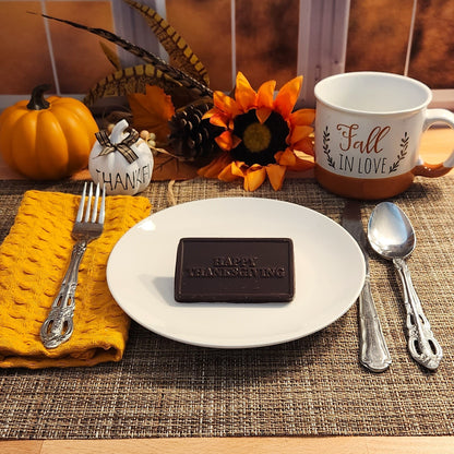 Our handmade dark chocolate card lets you say 'Happy Thanksgiving' in the most delightful way. This business card-sized sweet treat adds extra warmth to your Thanksgiving celebrations!