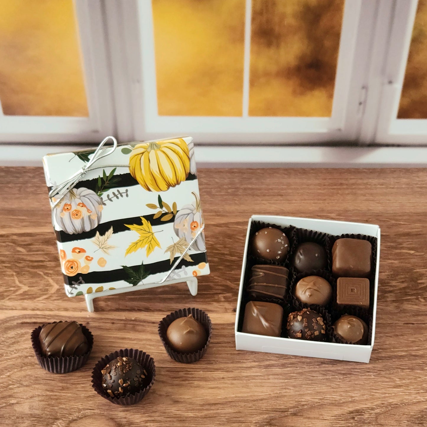 Celebrate the sweetness of the season with our Harvest Gathering Chocolate Assortment!  Available in a 9-piece or 16-piece box, this collection is filled with rich milk and dark chocolates, crafted in small batches right here in our candy kitchen.  Each bite is a surprise of flavor and texture, featuring silky creams, gooey caramels, melt-in-your-mouth meltaways, and decadent truffles that capture everything we love about fall.
