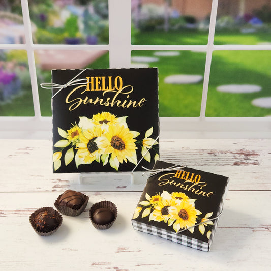 Get ready to brighten someone’s day—or your own—with our Milk & Dark Chocolate Popular Assortment, a delightful mix of chocolatey goodness wrapped in a cheerful Hello Sunshine with Sunflowers box!  Enjoy a mix of creams, caramels, melt-aways, and truffles in milk and dark chocolate.  Available in 9 or 16 pieces