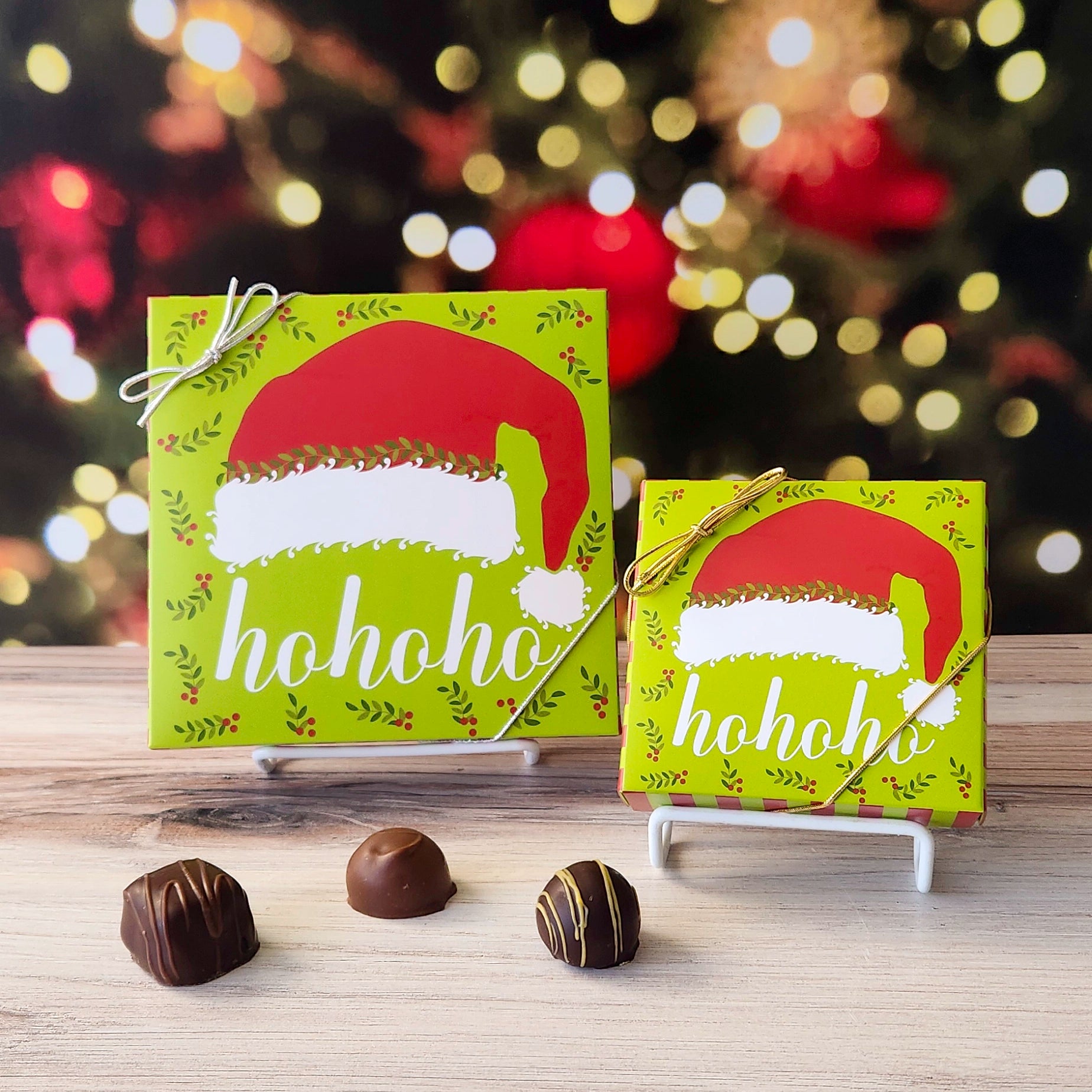 An assortment of our most popular milk and dark chocolate creams, caramels, melt-aways, and truffles all packed inside a box with the words "ho ho ho" under a Santa Claus hat printed on the cover.