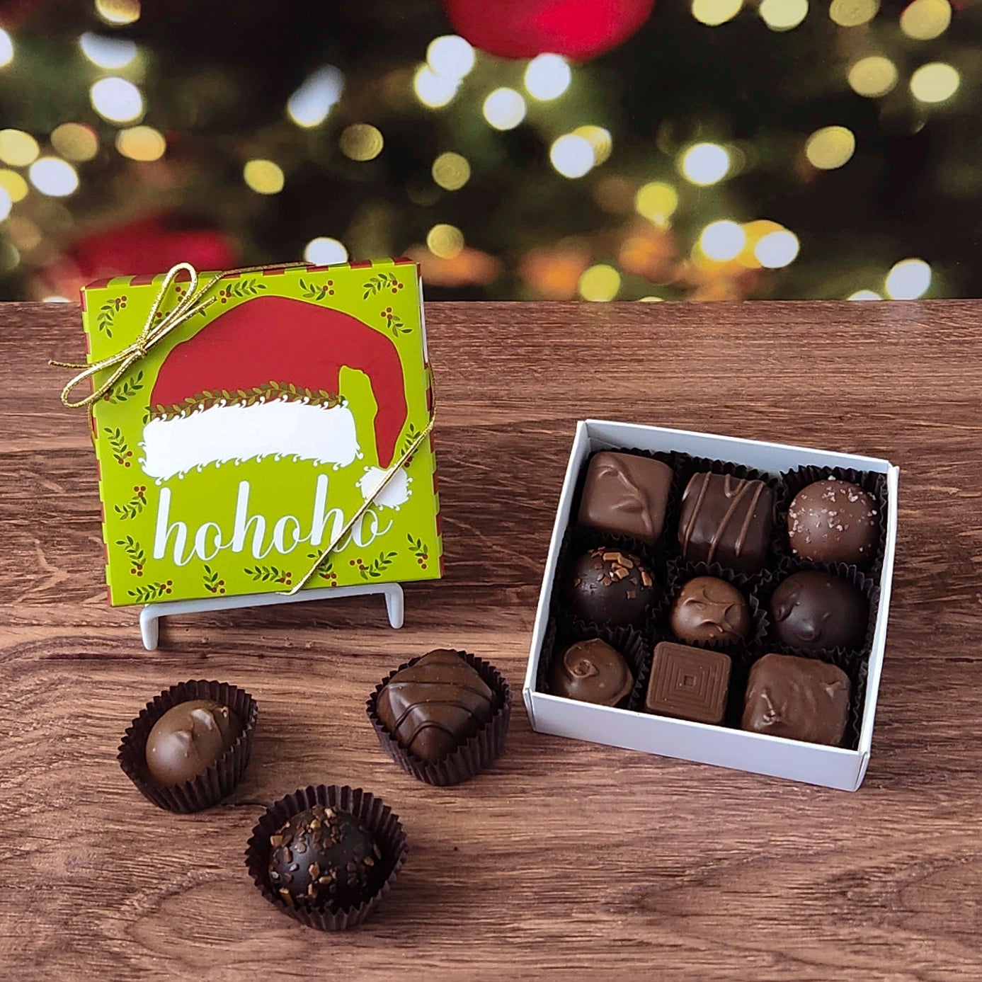 9 piece chocolate assortment box with ho ho ho Santa hat Christmas themed box.  Filled with a variety of creams, caramels, melt-aways and  truffles.