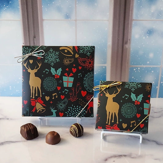 An assortment of our most popular milk and dark chocolate creams, caramels, melt-aways, and truffles all packed inside a box with holiday symbols printed on the cover.