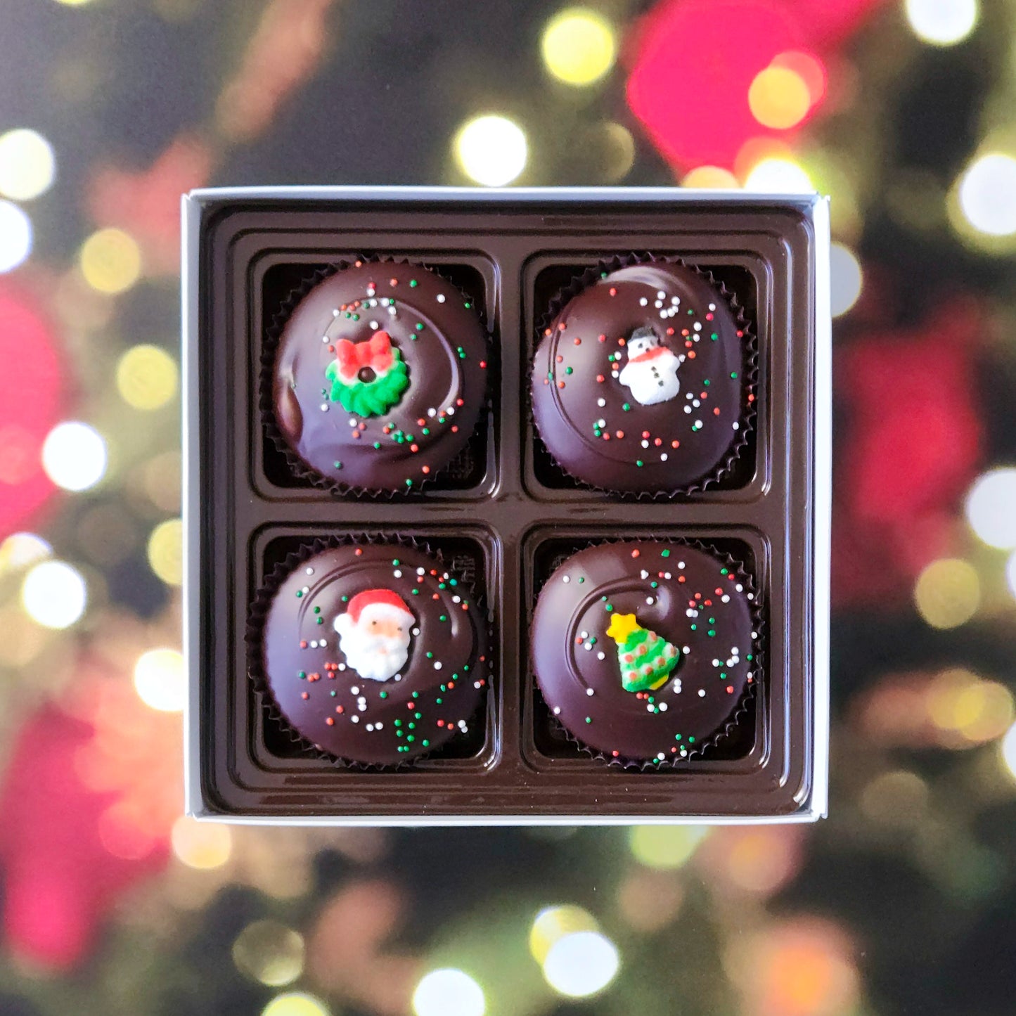 Surprise someone special with our Winter Holiday Peanut Butter Cup Gift Box! This delightful four-piece selection features handcrafted peanut butter cups, covered in rich dark chocolate, and topped with adorable sugar decorations for a festive touch