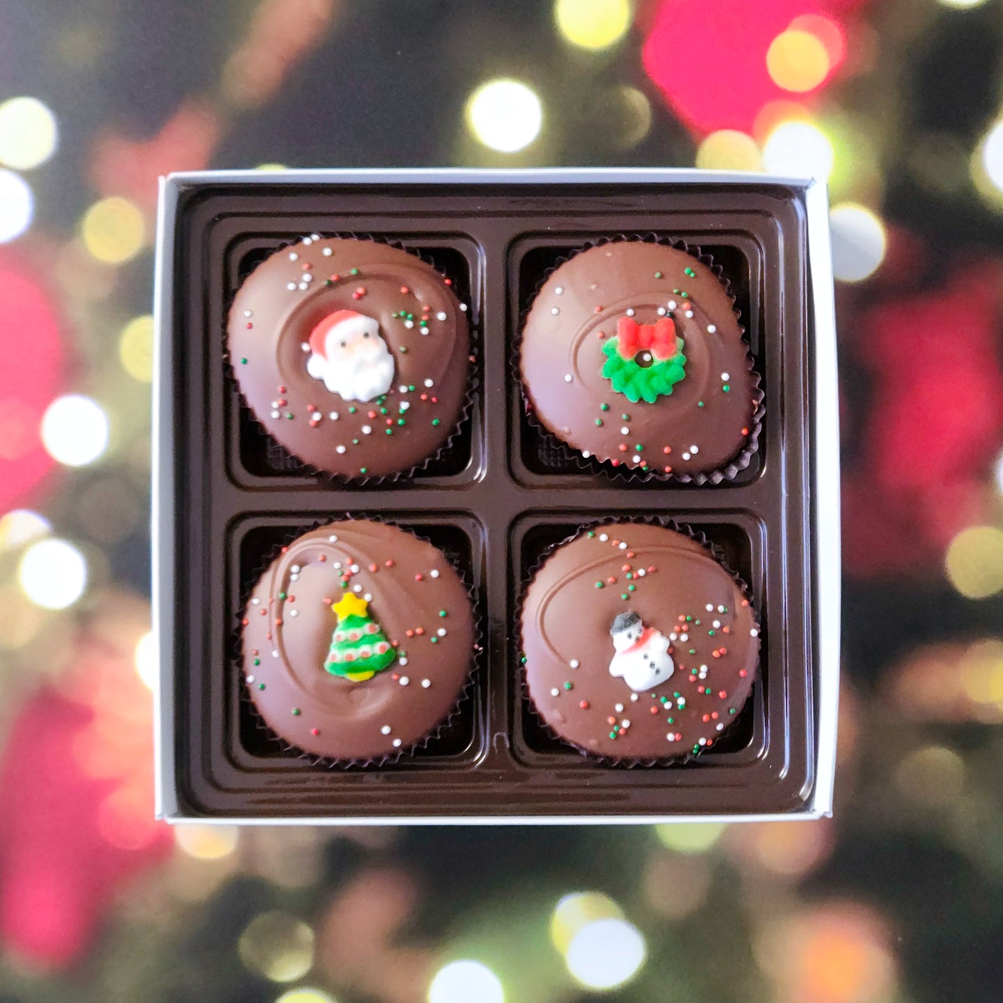 Surprise someone special with our Winter Holiday Peanut Butter Cup Gift Box! This delightful four-piece selection features handcrafted peanut butter cups, covered in smooth milk chocolate, and topped with adorable sugar decorations for a festive touch