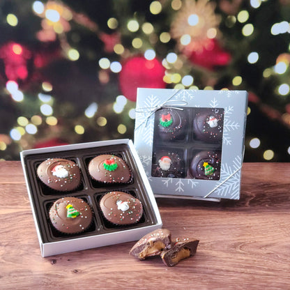 Surprise someone special with our Winter Holiday Peanut Butter Cup Gift Box! This delightful four-piece selection features handcrafted peanut butter cups, covered in your choice of smooth milk chocolate or rich dark chocolate, and topped with adorable sugar decorations for a festive touch