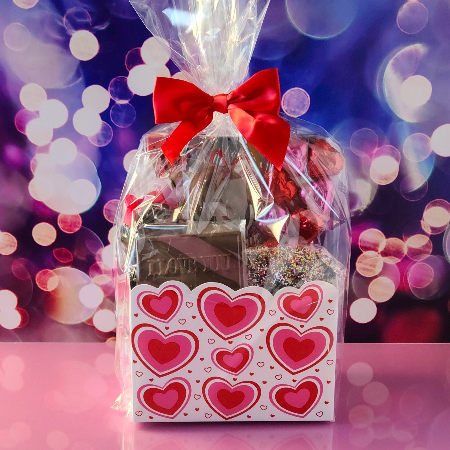 Make this Valentine’s Day unforgettable with our Valentine’s Day Gift Basket featuring:
Dark Chocolate Covered Cranberries, Milk Chocolate Oreos ,  Milk Chocolate Nonpareils, Milk Chocolate Foil Hearts, A 16-piece Assortment and a charming Milk Chocolate Card that says I Love You, the sweetest way to express your feelings.