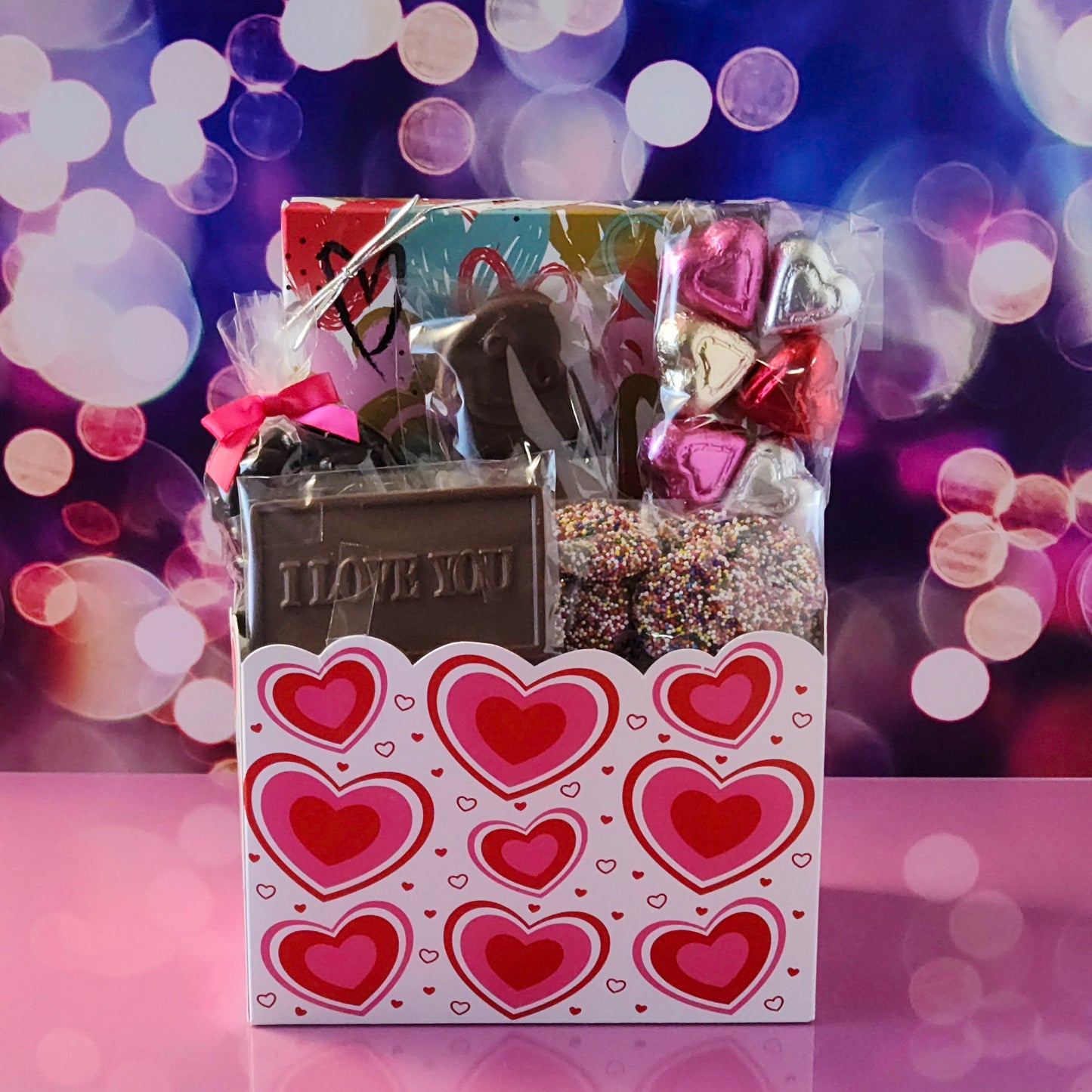 Make this Valentine’s Day unforgettable with our Valentine’s Day Gift Basket featuring:
Dark Chocolate Covered Cranberries, Milk Chocolate Oreos ,  Milk Chocolate Nonpareils, Milk Chocolate Foil Hearts, A 16-piece Assortment and a charming Milk Chocolate Card that says I Love You, the sweetest way to express your feelings.