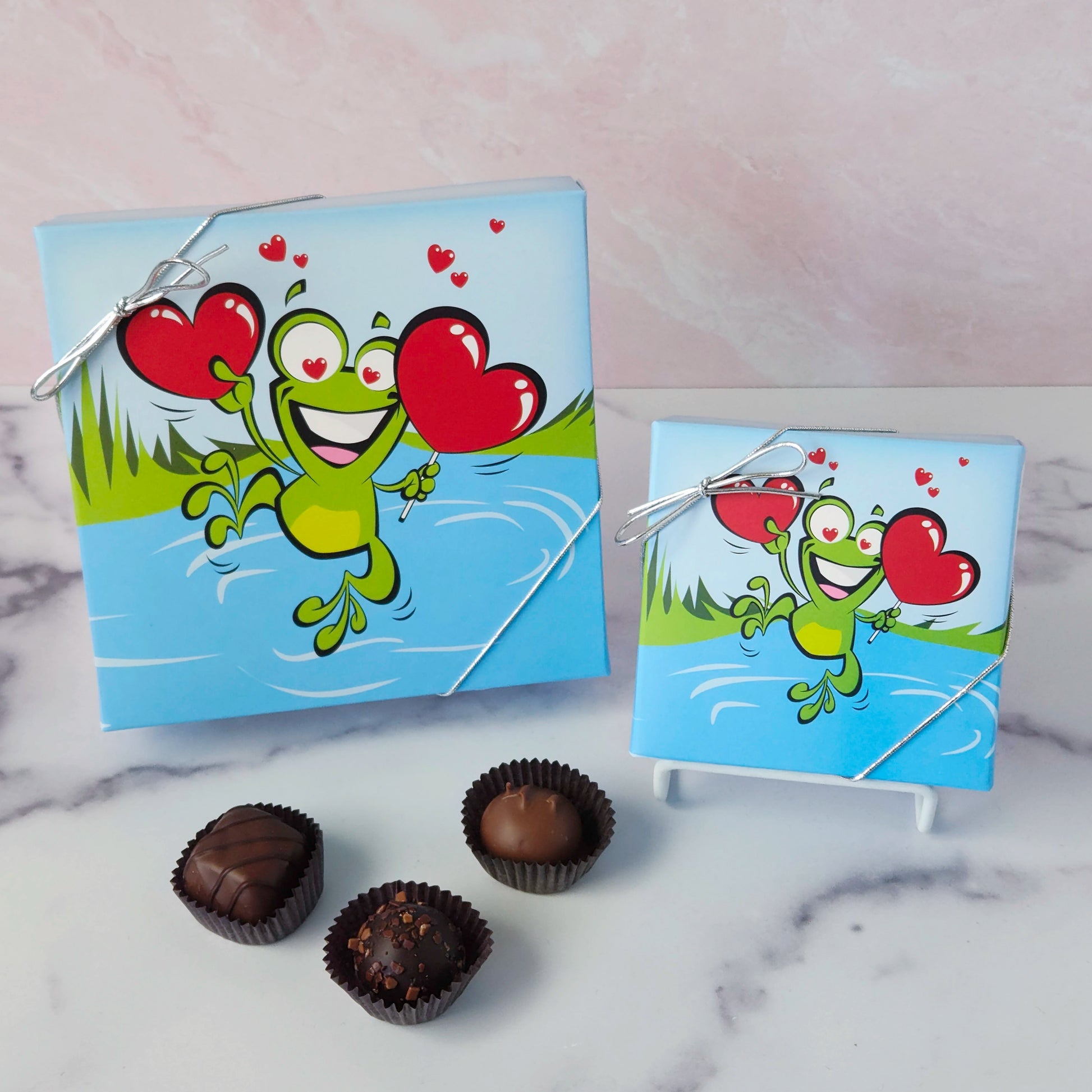 Hop into a world of chocolatey bliss with our Leaping Frog Chocolate Assortment! Bursting with rich milk and dark chocolate favorites, this festive 9-piece or 16-piece box is perfect for anyone who loves a little whimsy with their sweets.
Inside, you'll discover a delicious variety of handmade favorites: silky meltaways, buttery caramels, rich truffles, and smooth, dreamy creams.