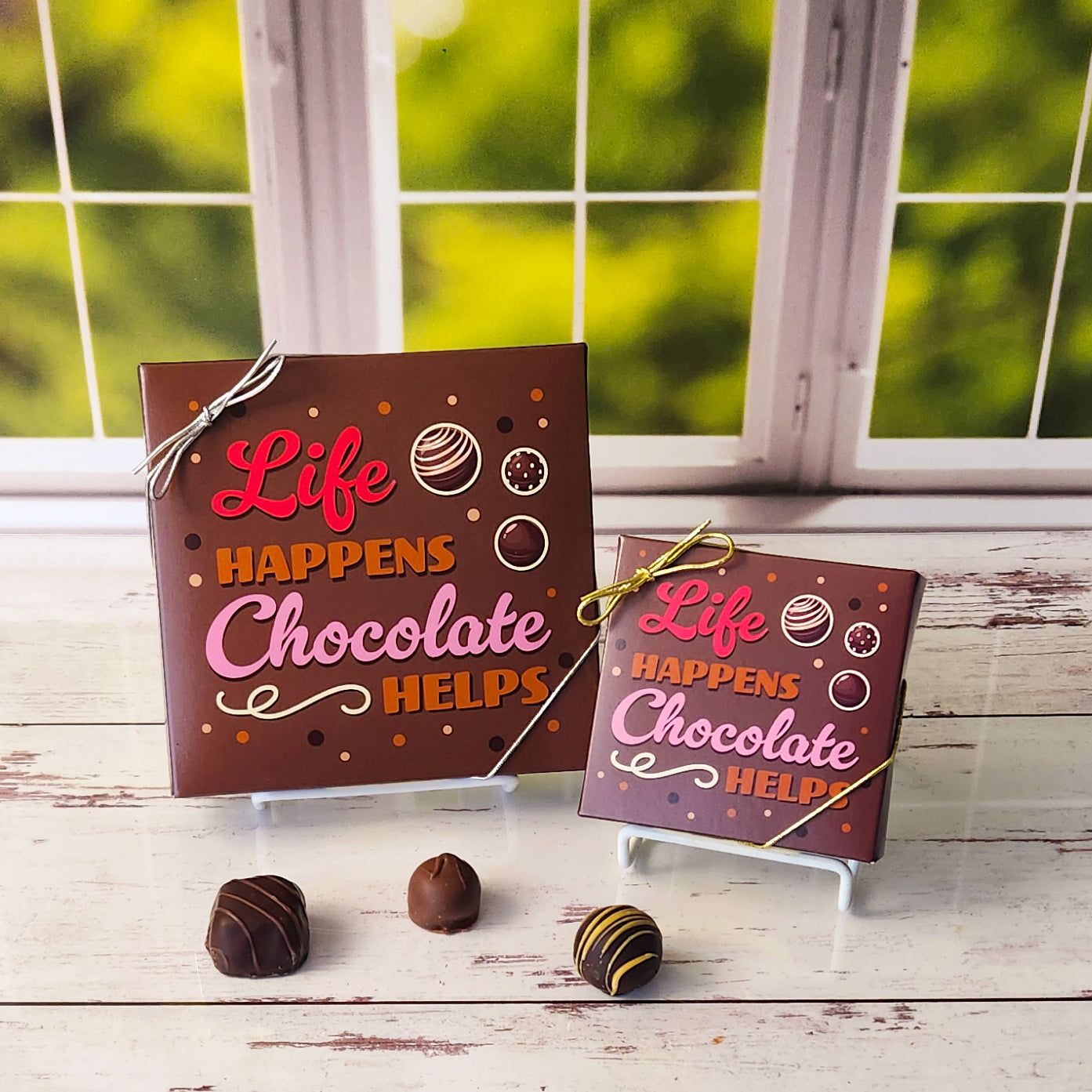 An assortment of our most popular milk and dark chocolate creams, caramels, melt-aways, and truffles all packed inside a fun printed box. The cover of the box says "Life Happens Chocolate Helps"