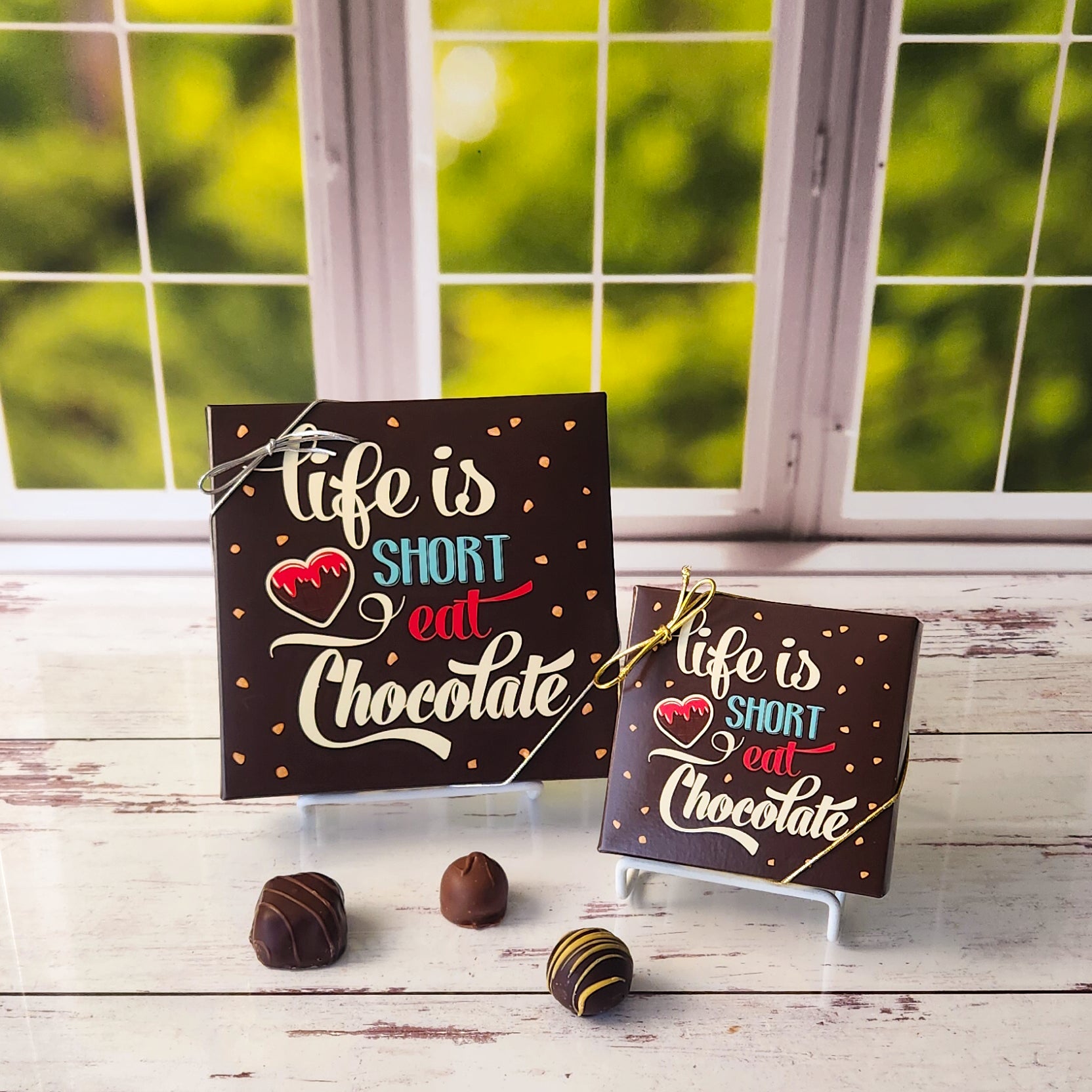 An assortment of our most popular milk and dark chocolate creams, caramels, melt-aways, and truffles all packed inside a fun printed box. The cover of the box says "Life is Short Eat Chocolate"