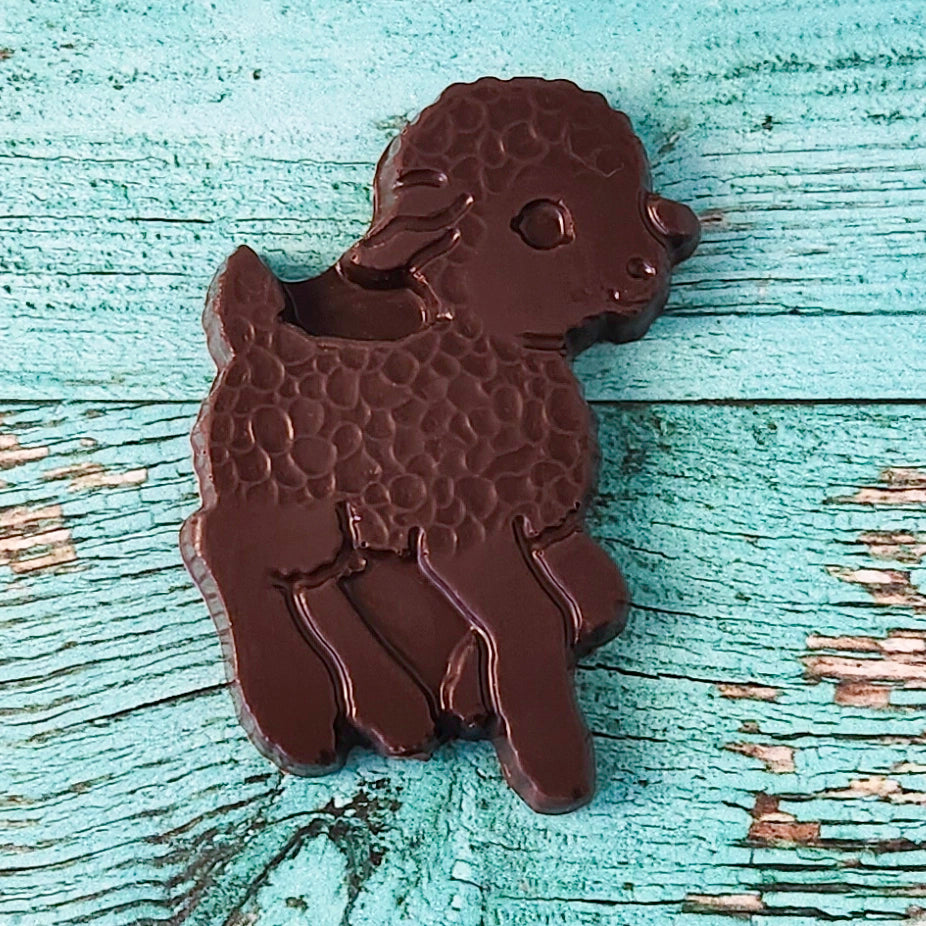 Chocolate lamb-shaped favor on a textured wooden surface
